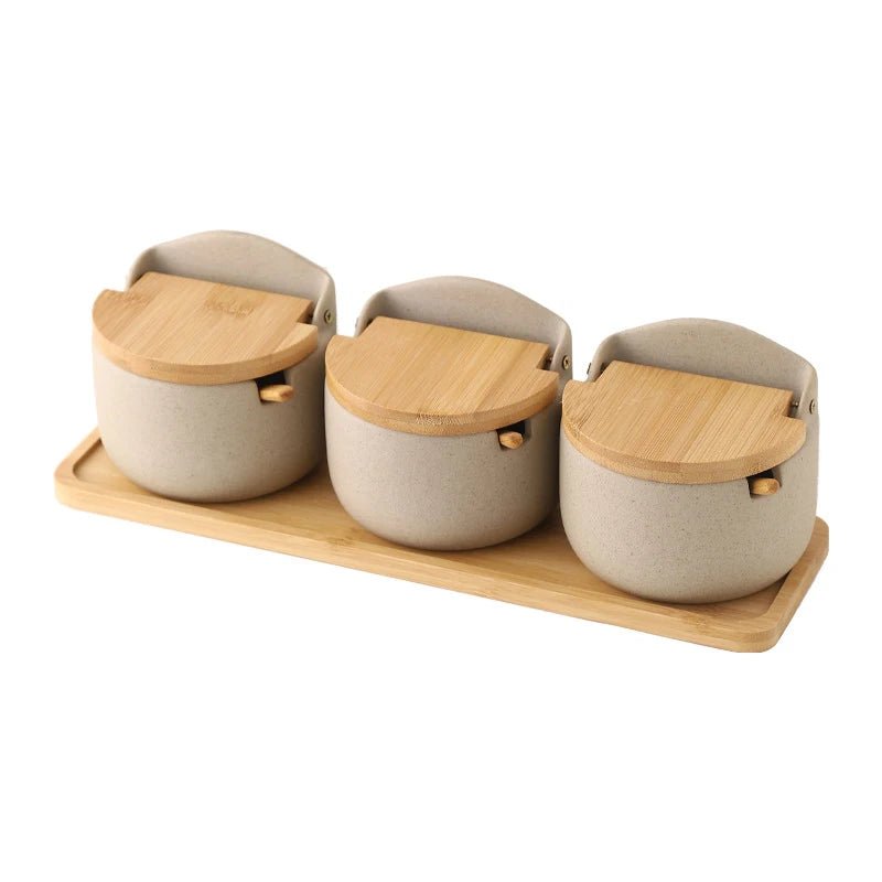 Three sets of ceramic seasoning jars with wooden lids, neatly arranged