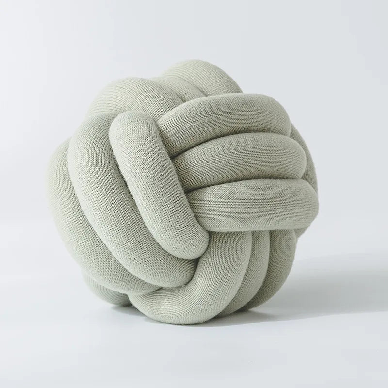 Stylish Knot Ball Sofa Cushion in a modern living room setting, featuring a soft, plush design