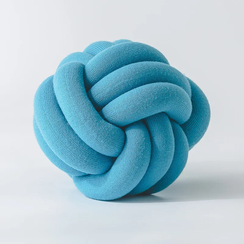 Stylish Knot Ball Sofa Cushion in a modern living room setting, featuring a soft, plush design