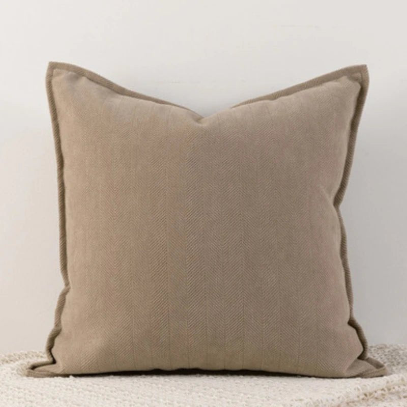 An aplicot Nordic cushion cover placed over a couch, showcasing its delicate and cozy texture.