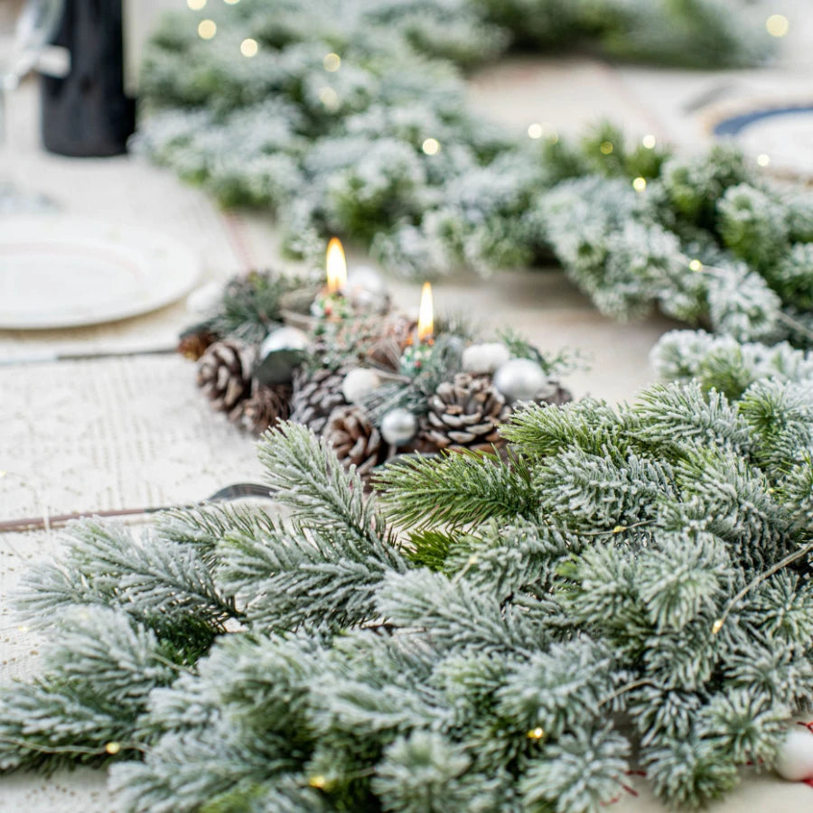 Artificial Christmas tree branch in green and white, ideal for festive table or fireplace decor.