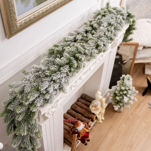 Artificial Christmas tree branch in green and white, ideal for festive table or fireplace decor.