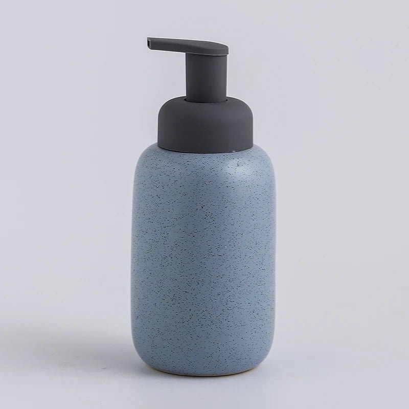 A blue ceramic soap dispenser with a sleek design, ideal for modern bathroom decor.