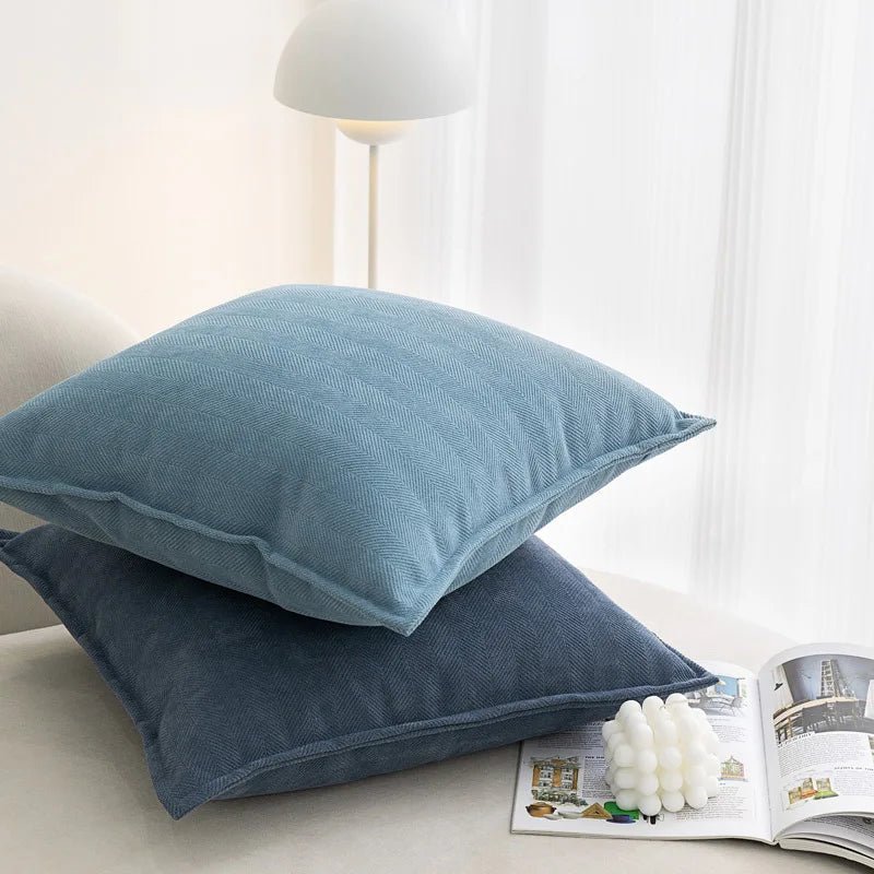 A blue Nordic cushion cover placed over a couch, showcasing its delicate and cozy texture.