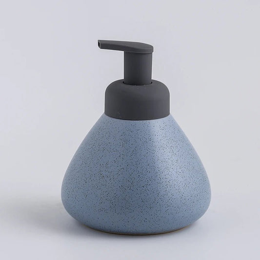 A blue ceramic soap dispenser with a sleek design, ideal for modern bathroom decor.