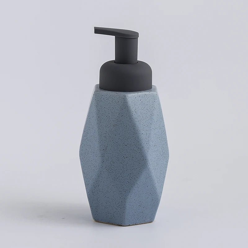 A blue ceramic soap dispenser with a sleek design, ideal for modern bathroom decor.