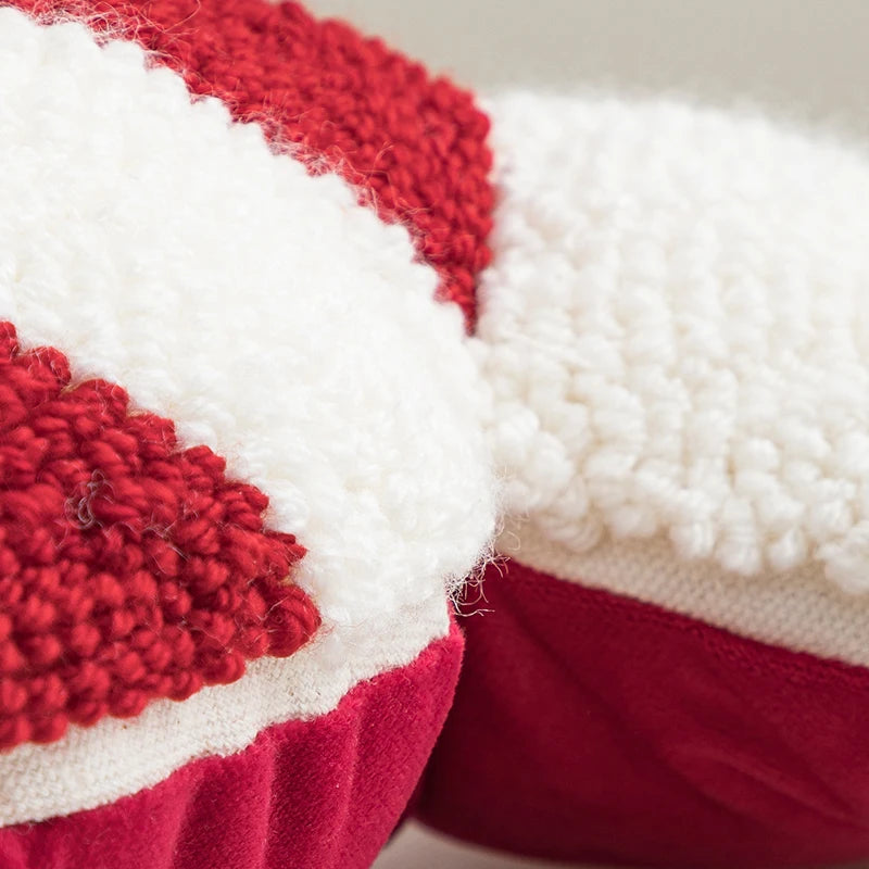 soft candy cane-shaped pillows with red and white stripes.