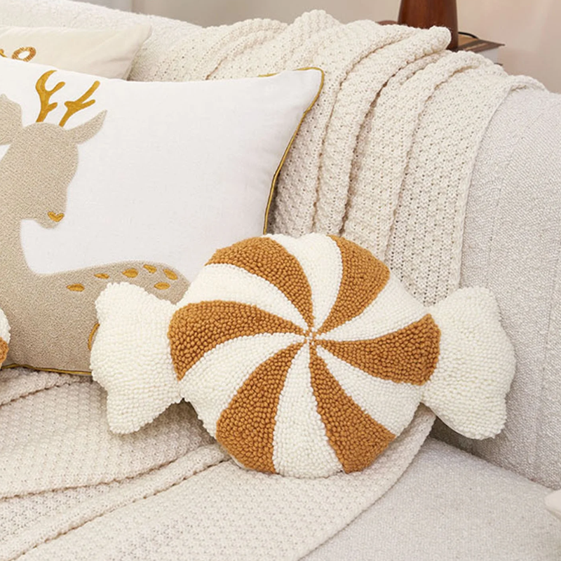 soft candy cane-shaped pillows with gold and white stripes.