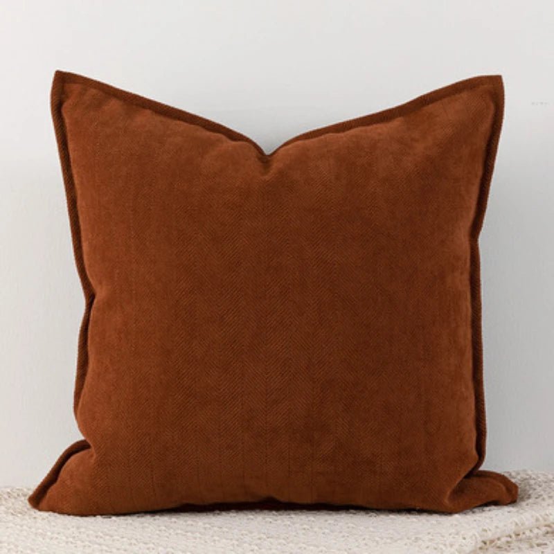 A caramel Nordic cushion cover placed over a couch, showcasing its delicate and cozy texture.