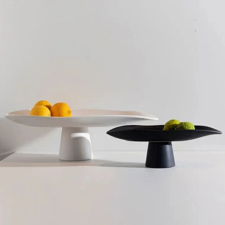 Modern ceramic high centerpiece tray in black or white with curvy, irregular lines, perfect as decor or fruit holder.