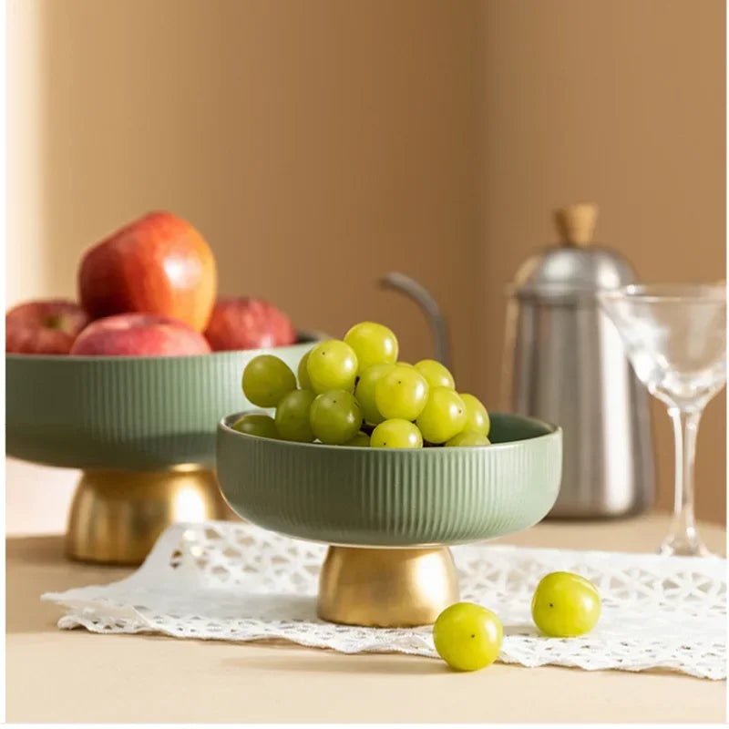 Two ceramic fruit bowls filled with grapes and apples