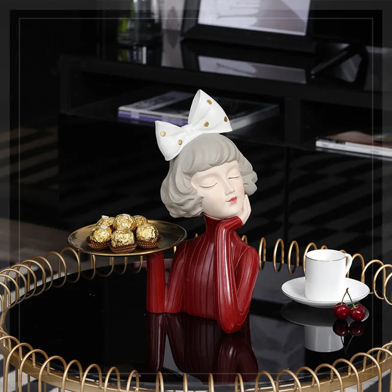 A charming girl statue holding a tray, perfect as a decorative piece.