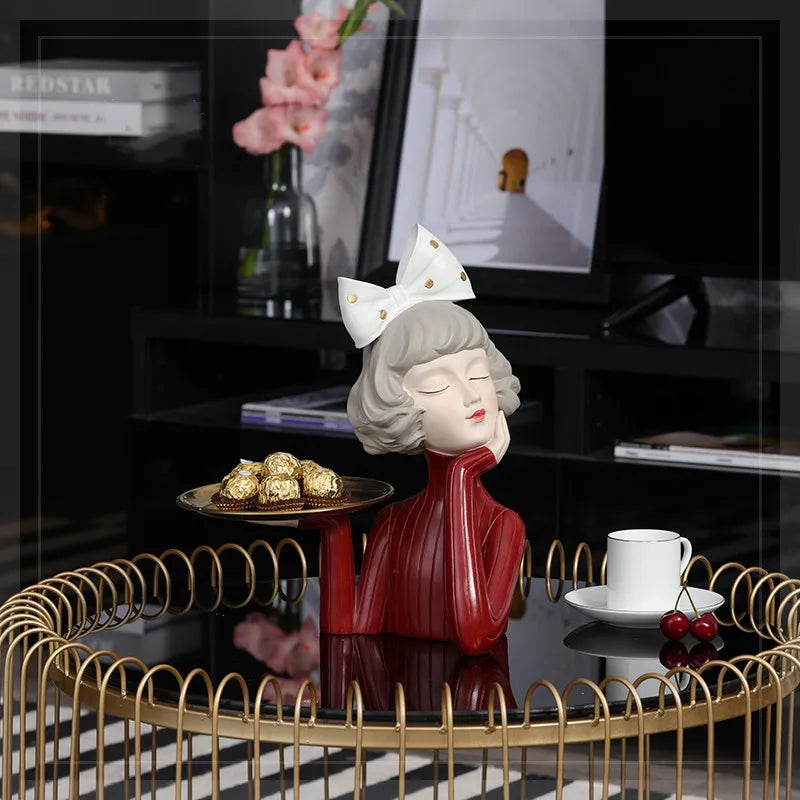 A charming girl statue holding a tray, perfect as a decorative piece.