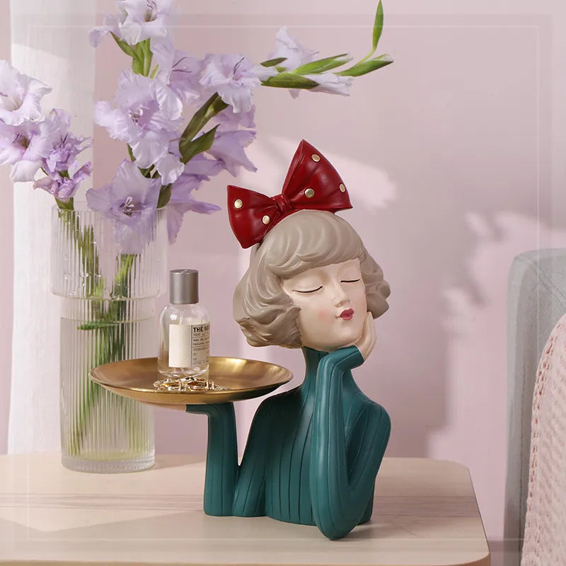 A charming girl statue holding a tray, perfect as a decorative piece.