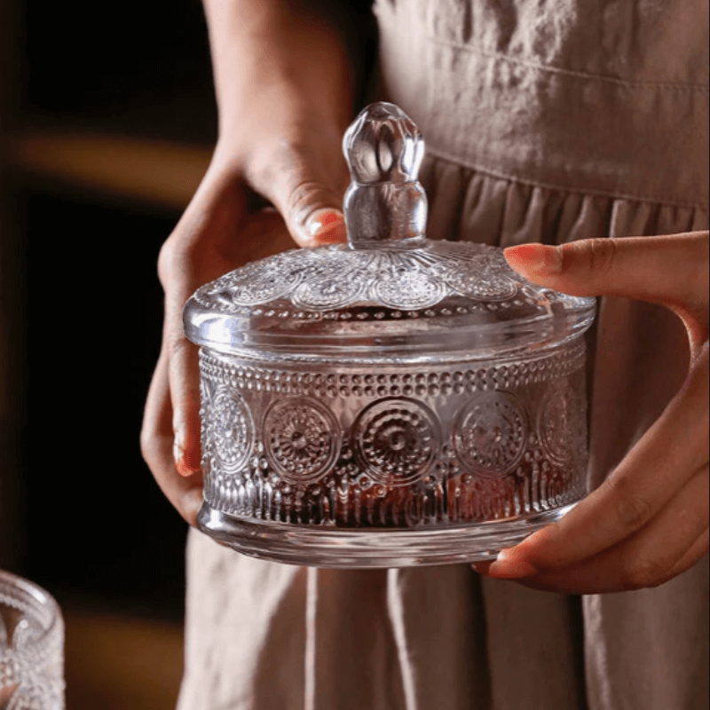 Classic engraved triple-tier glass jar with elegant design, perfect for storage and display in kitchen or home decor.