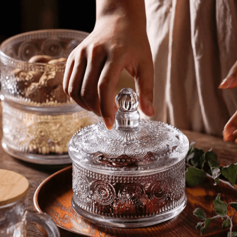 Classic engraved triple-tier glass jar with elegant design, perfect for storage and display in kitchen or home decor.