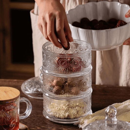 Classic engraved triple-tier glass jar with elegant design, perfect for storage and display in kitchen or home decor.