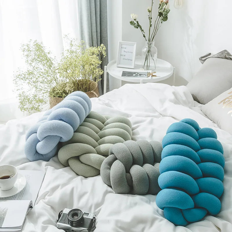 A comfy handmade knot pillow in a modern design, perfect for adding a decorative touch to any living space