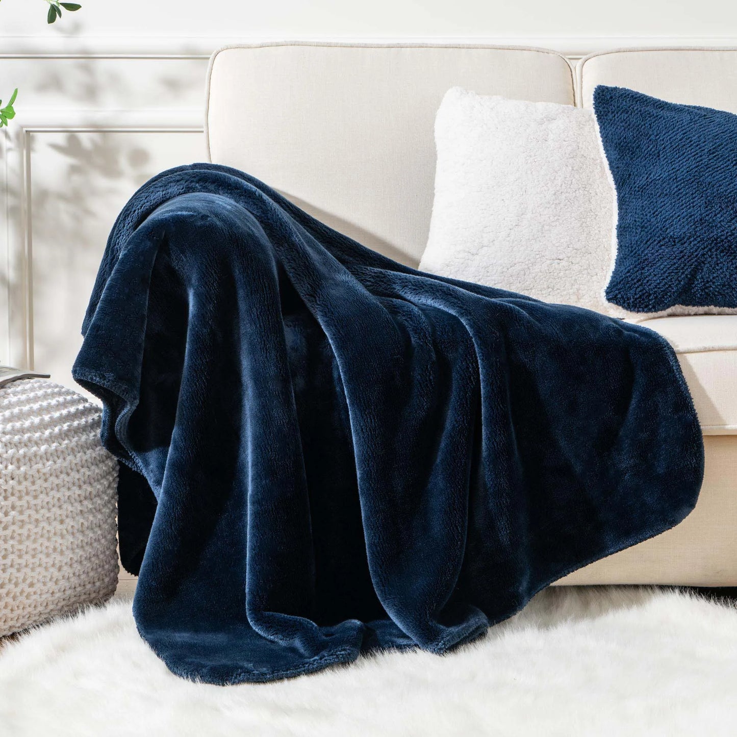 Cozy heavyweight plush flannel blanket draped over a couch, showcasing its thick and fuzzy texture.