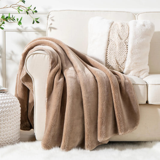 Cozy heavyweight plush flannel blanket draped over a couch, showcasing its thick and fuzzy texture.