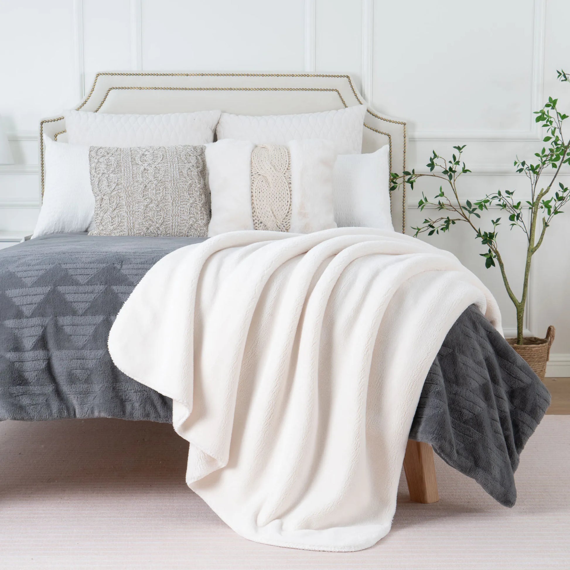 Cozy heavyweight plush flannel blanket draped over a couch, showcasing its thick and fuzzy texture.