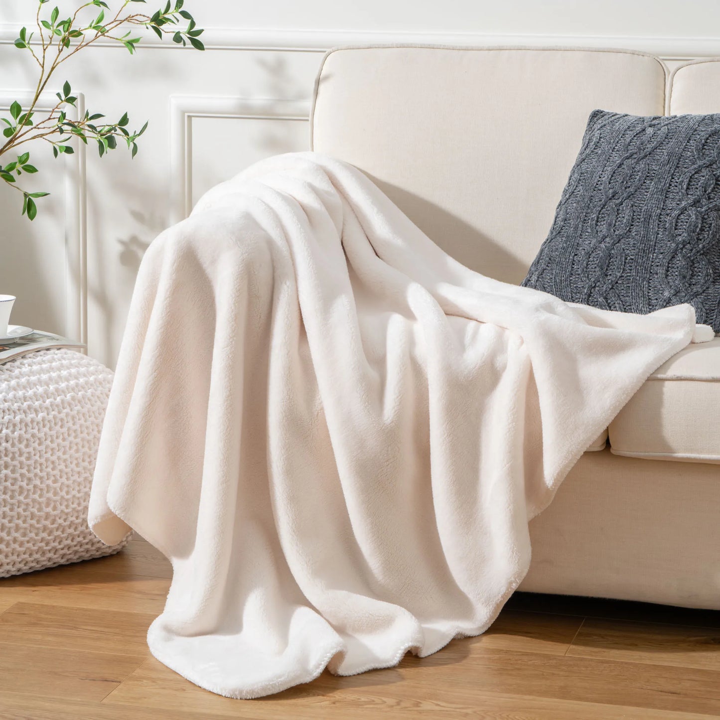 Cozy heavyweight plush flannel blanket draped over a couch, showcasing its thick and fuzzy texture.