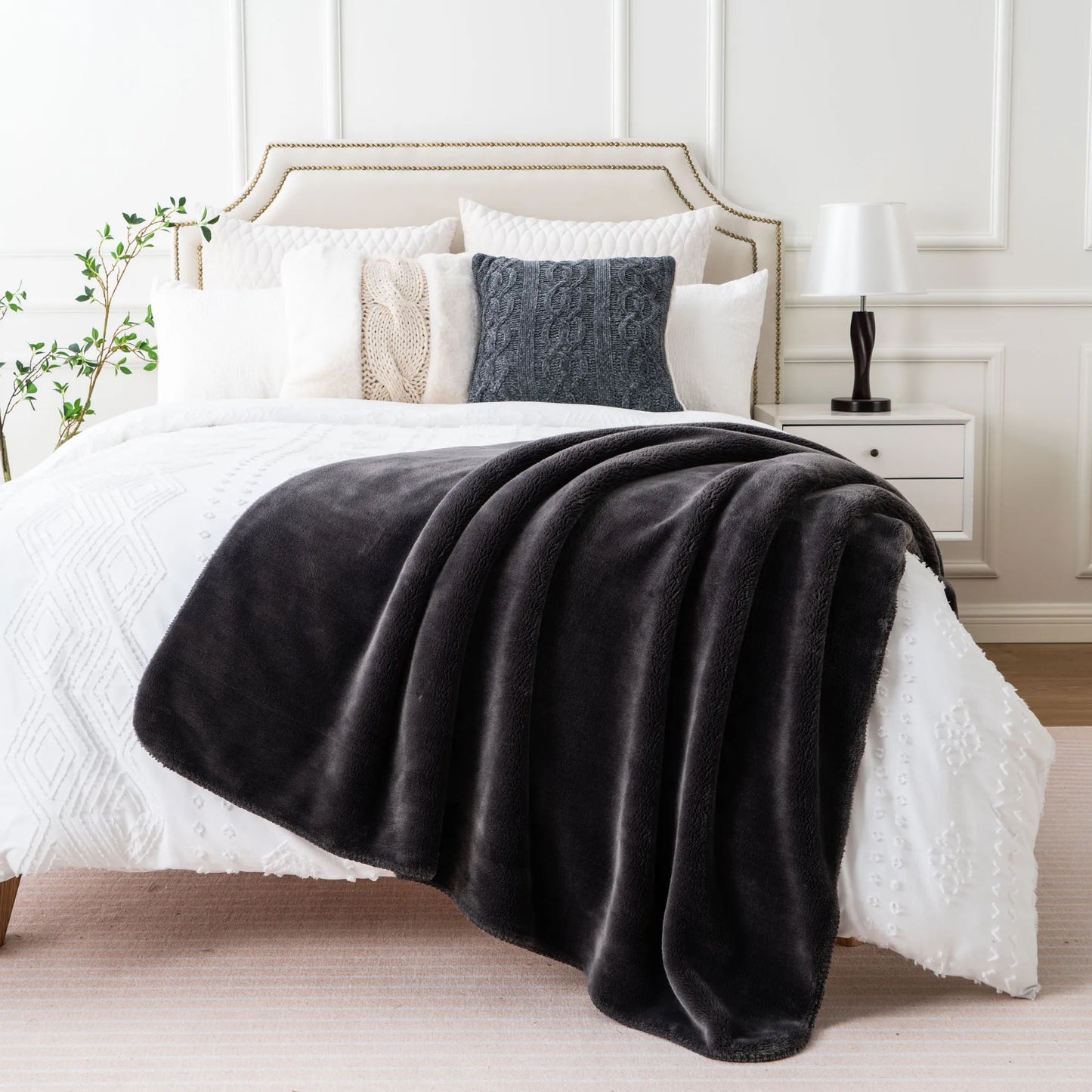 Cozy heavyweight plush flannel blanket draped over a couch, showcasing its thick and fuzzy texture.