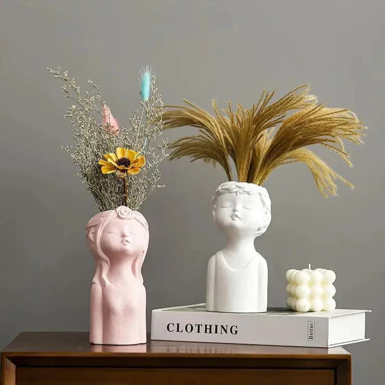 Cute ceramic boy and girl statue vases for modern home décor, perfect for child’s bedroom or living spaces.