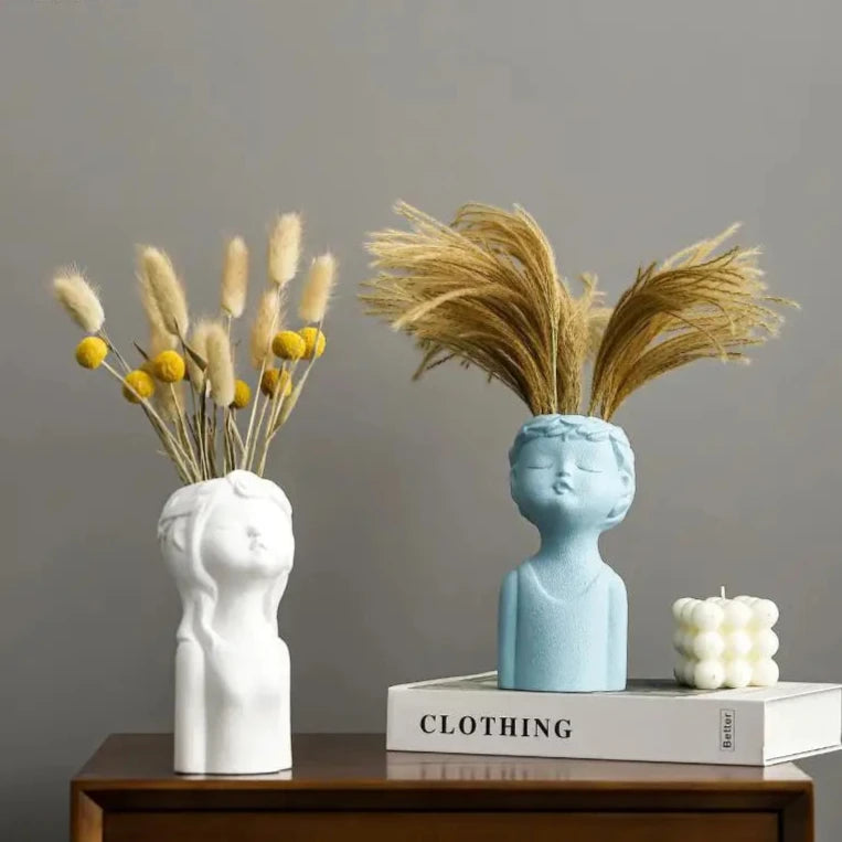 Cute ceramic boy and girl statue vases for modern home décor, perfect for child’s bedroom or living spaces.