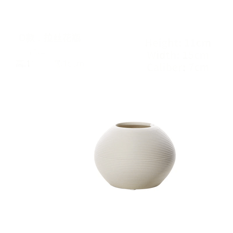 Elegant white brushed ceramic vase iin a white background.