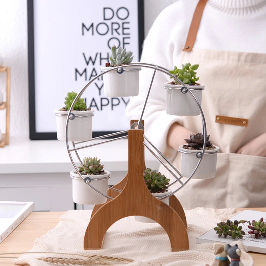 Ferris wheel plant rack featuring steel stands and four ceramic pots for stylish plant display.