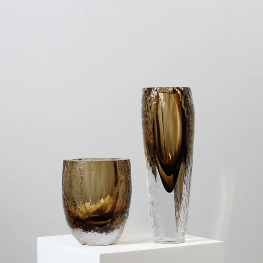 A glass vase in soft smoky brown, blending smooth and textured glass. Perfect for long stems or as a stand-alone piece. Strong, weighty and timeless.
