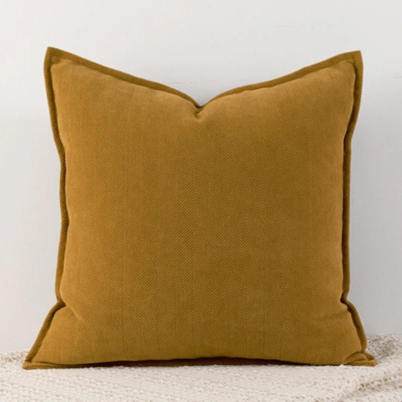 A ginger Nordic cushion cover placed over a couch, showcasing its delicate and cozy texture.