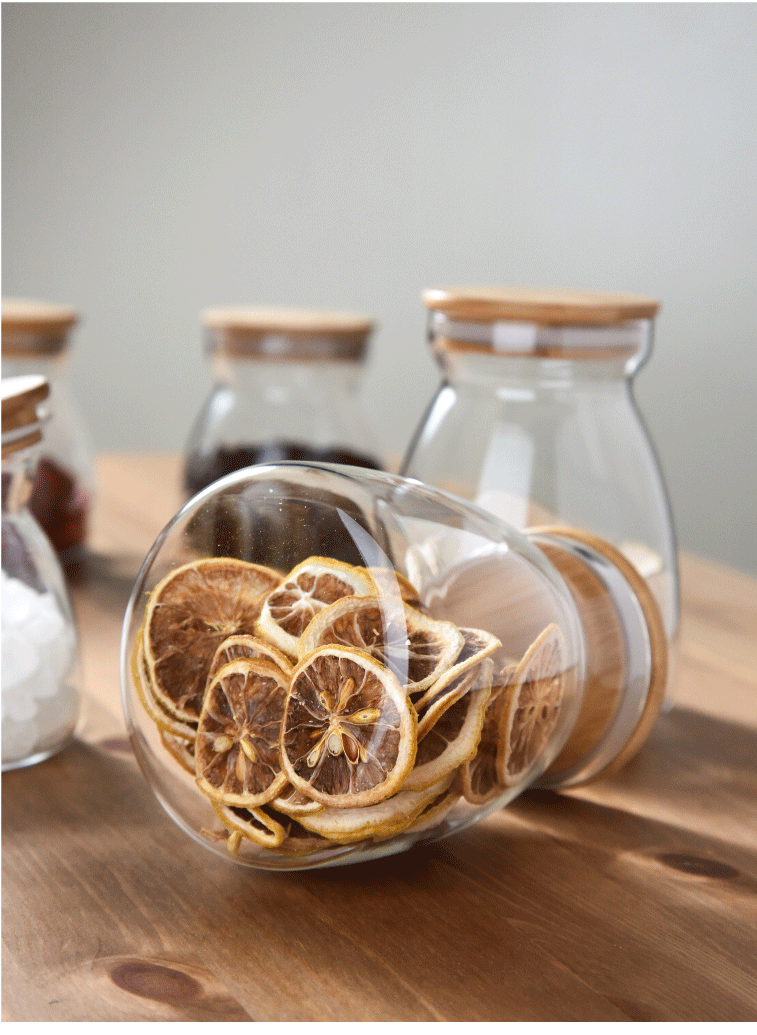 Glass Jar with wooden lid filled with dried slices of lemon