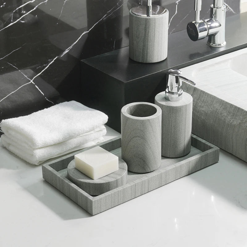 A sophisticated gray natural marble bathroom set, featuring a sleek soap dispenser, toothbrush holder, and soap dish, all crafted with premium marble for a modern and luxurious look.