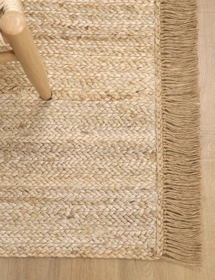 Hand-woven natural jute rug with tassels. Perfect for adding boho and Scandinavian charm to any space, durable and easy to care for. Ideal for contemporary décor.