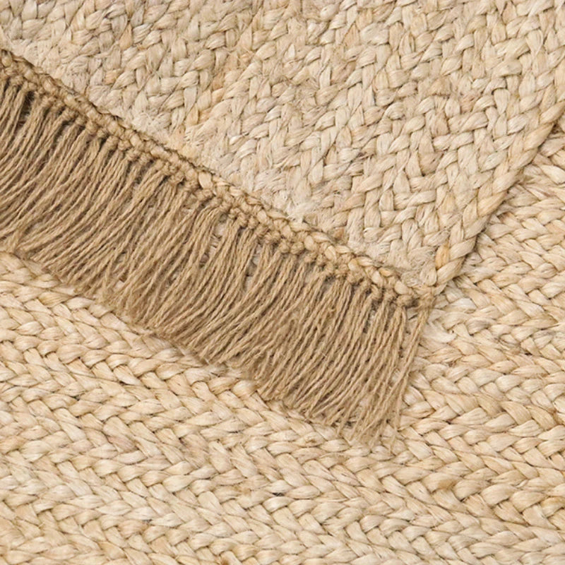 Hand-woven natural jute rug with tassels. Perfect for adding boho and Scandinavian charm to any space, durable and easy to care for. Ideal for contemporary décor.