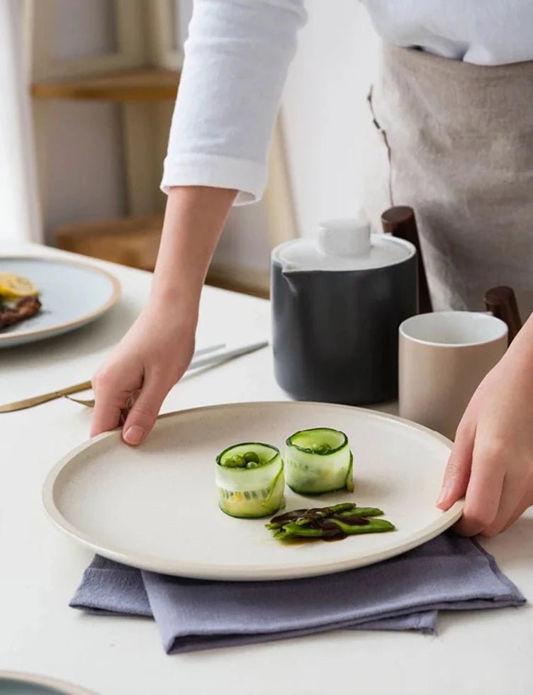 Japanese matte ceramic tableware in beige on a white table.