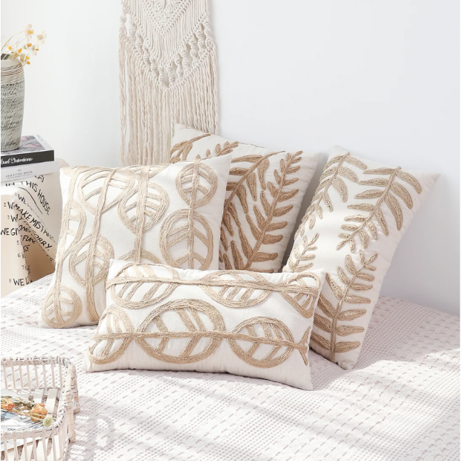 Boho-style linen pillow cover with beige fabric and embroidered leaf designs, ideal for adding charm and harmony to your home decor.