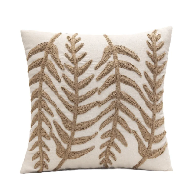 Boho-style linen pillow cover with beige fabric and embroidered leaf designs, ideal for adding charm and harmony to your home decor.