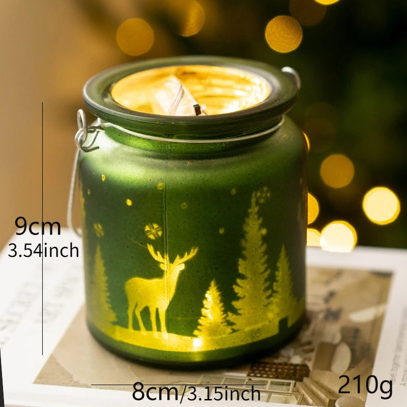 Christmas glass candle holders with etched winter scenes of pine trees and reindeer.