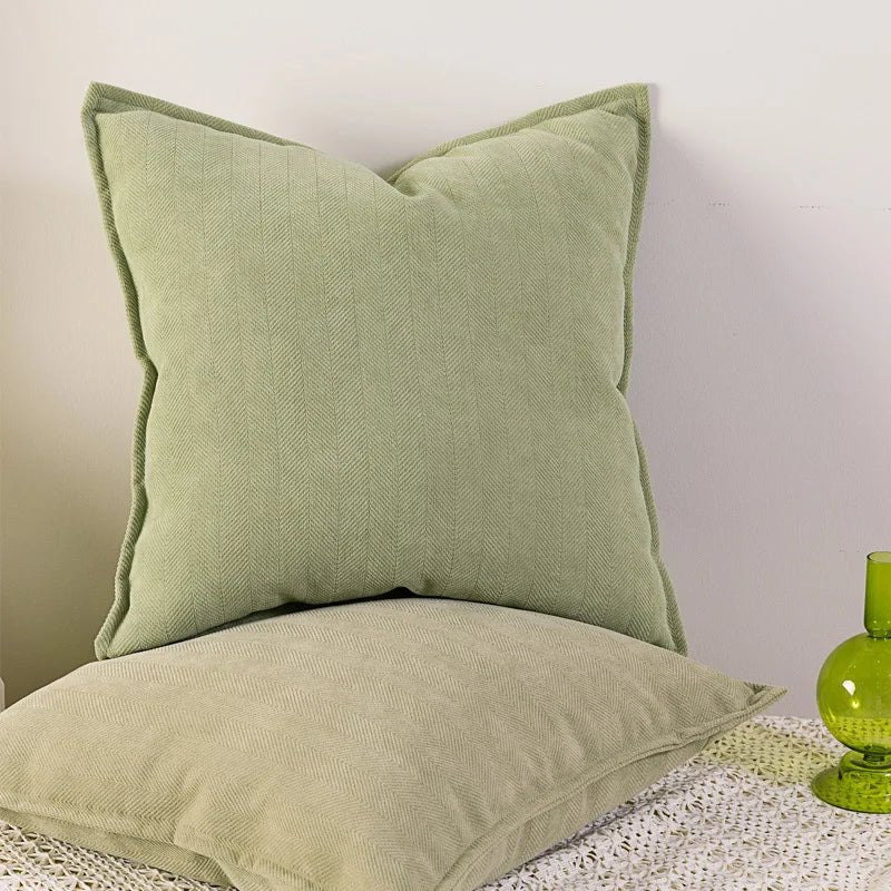 A matcha green Nordic cushion cover placed over a couch, showcasing its delicate and cozy texture.