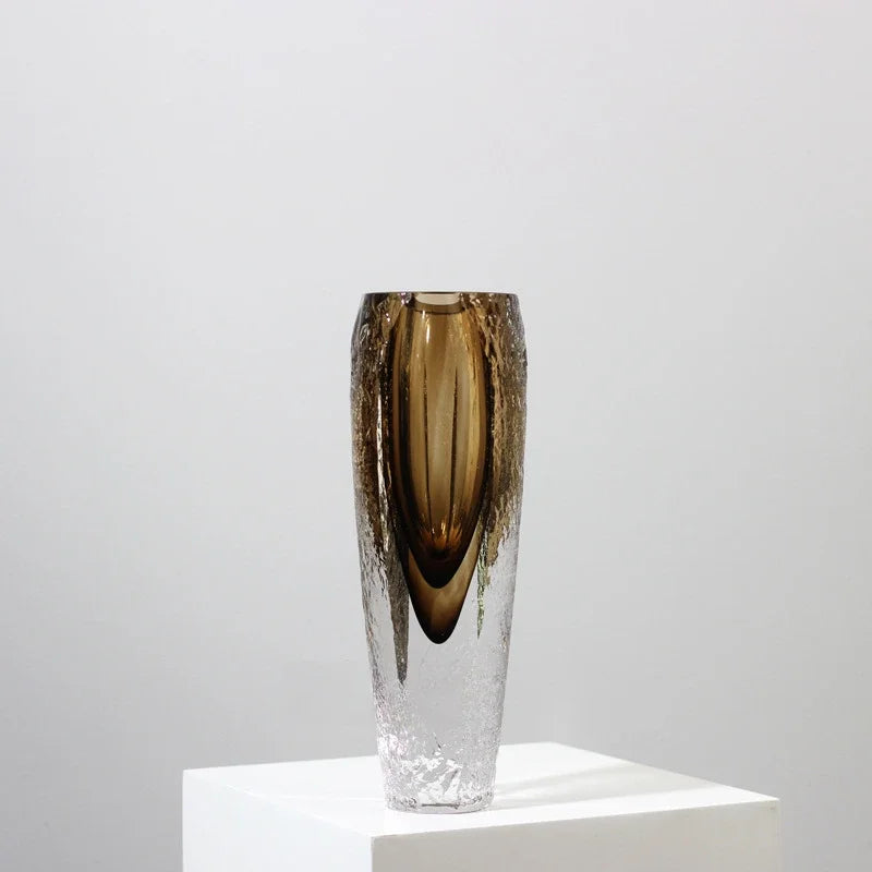 A glass vase in soft smoky brown, blending smooth and textured glass. Perfect for long stems or as a stand-alone piece. Strong, weighty and timeless.