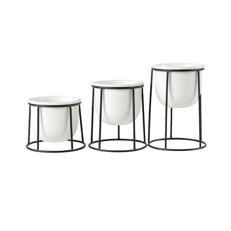 A modern trio flowerpot set, perfect for small plants, featuring three sleek, minimalist pots in varying sizes and colors