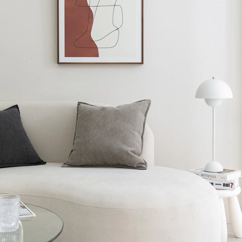 A gray Nordic cushion cover placed over a couch, showcasing its delicate and cozy texture.