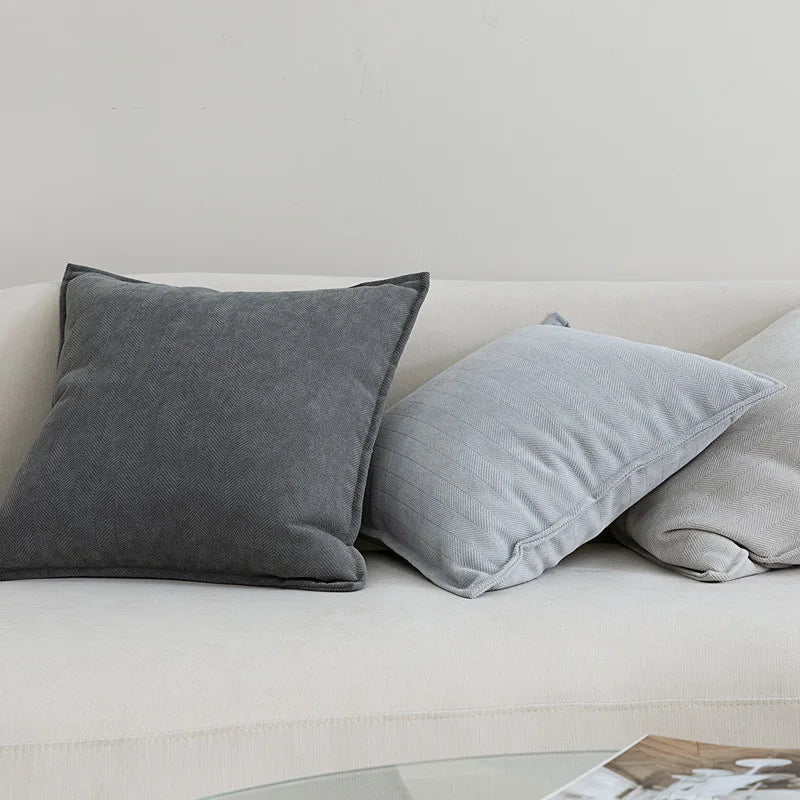 Two Nordic cushion cover placed over a couch, showcasing their delicate and cozy texture.