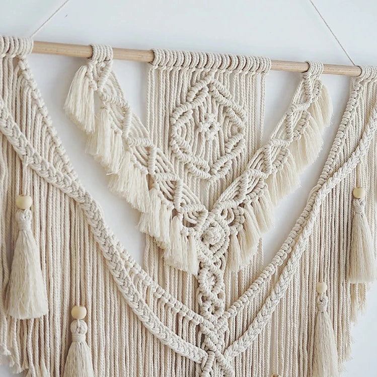 Hand-woven macrame wall hanging in Nordic boho style, featuring tassels and 100% cotton material. Perfect for adding a cozy and natural touch to any space.