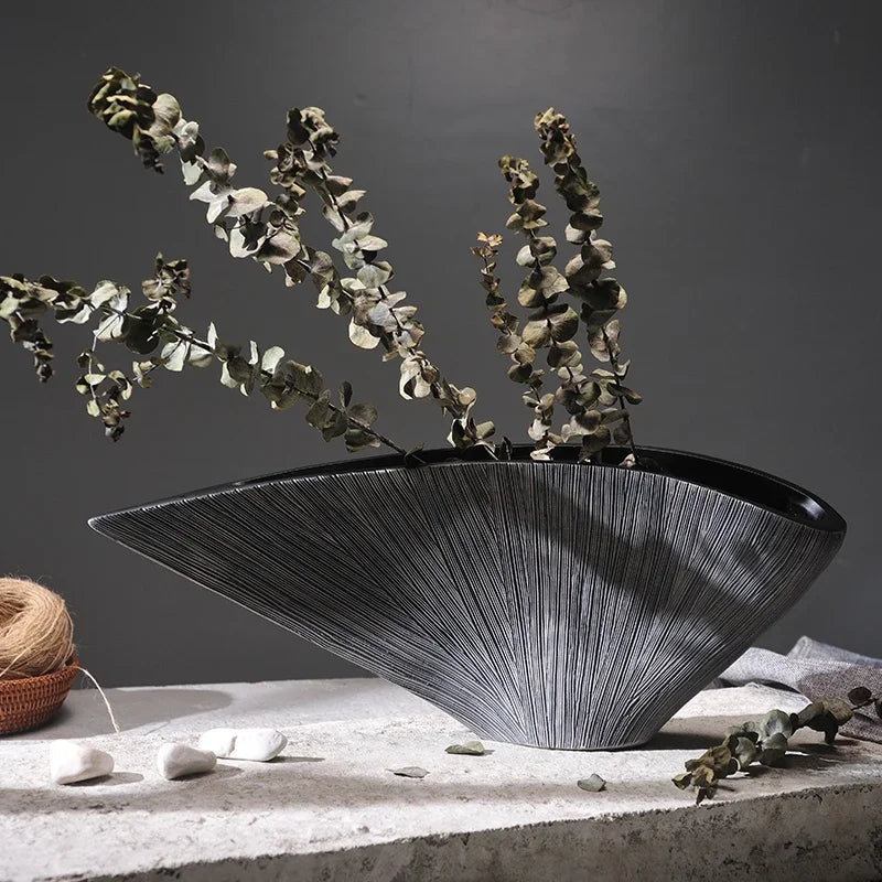 Creative Nordic-style resin vase with an abstract shell design in dark grey and black tones, perfect for adding modern sophistication to any room.