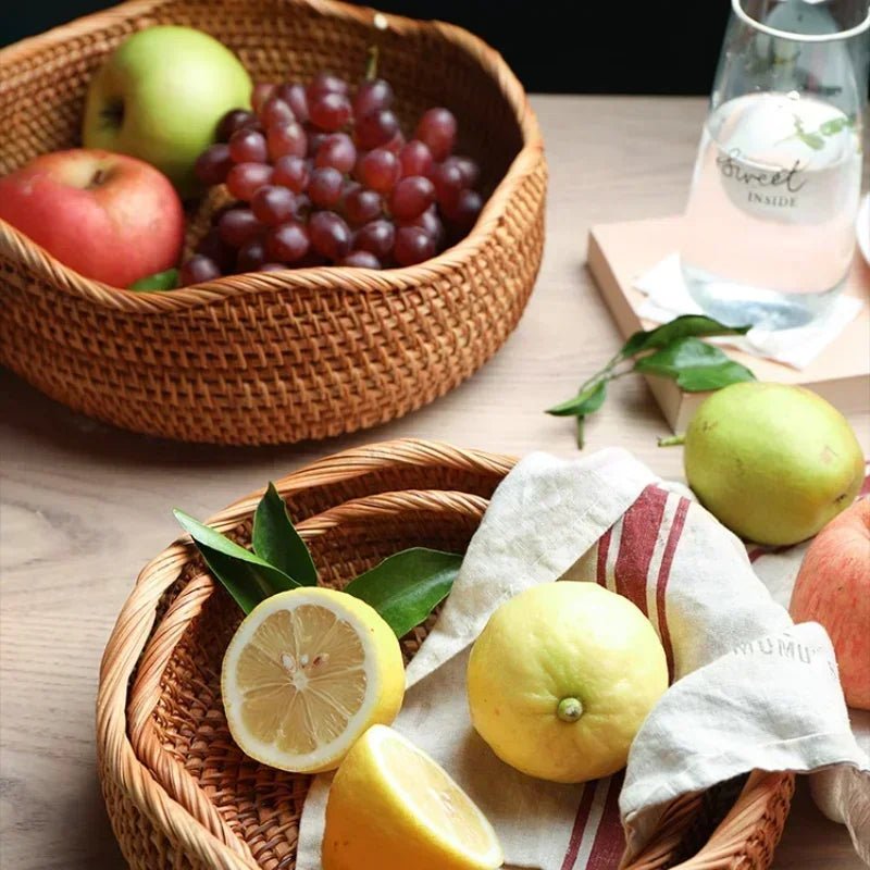 Two octagonal rustic fruit baskets filled with grapes, apples, and various other fruits.