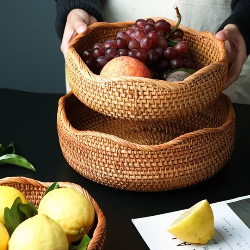 Two octagonal rustic fruit baskets filled with grapes, apples, and various other fruits